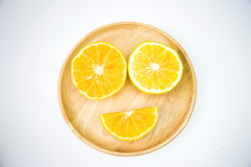 Fototapeta na wymiar Orange put on a wooden plate To feel happy, smiling, funny.