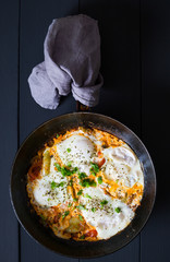 Shakshuka and pita. Scrambled eggs with vegetables and spices