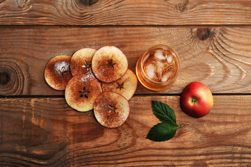 Apple cider with ice in a glass and slices of Apple