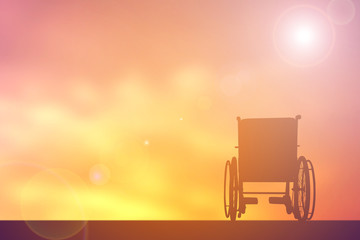 Silhouette wheelchair on sunset