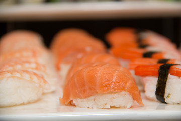  Sushi rolls on a white plate.