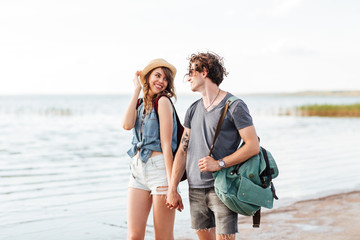 Beautiful young couple in love walking at the beach