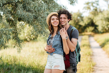 Young attractive hipster couple hugging at the forest