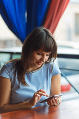 A young woman is using her smart phone