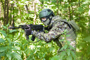 Forces soldiers in the woods with a Kalashnikov