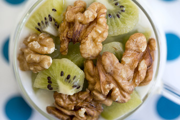 Glass with Plain yogurt with kiwi and nuts