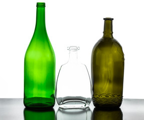 colored empty glass bottles for wine isolated on white background