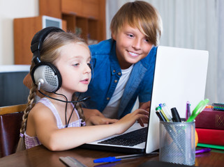Teenager and sister surfing internet