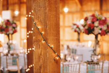 Wooden columns decorated with light garlands