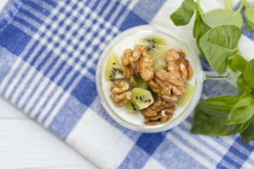 Glass with Plain yogurt with kiwi and nuts
