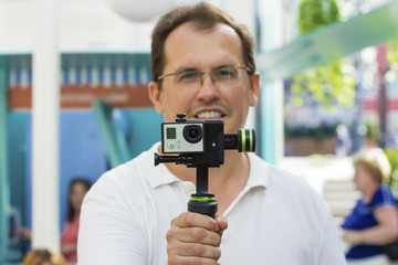 Man holds small action camera