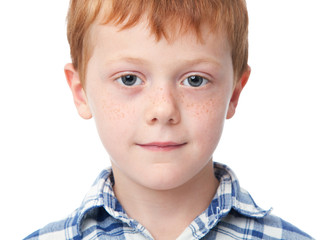 Close up face of a smiling ginger boy isolated on white background