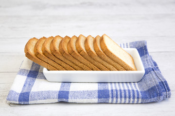 A group of rusks on a white platter