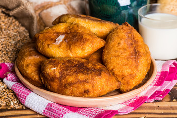 Traditional homemade pies with cabbage and sauerkraut on a plate