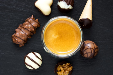 Selected chocolate pralines with coffee cup