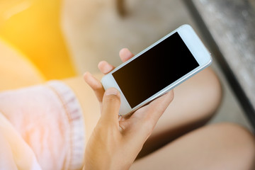 Woman use mobile phone in coffee shop from backside view.