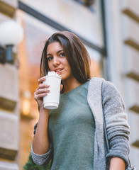 Smiling teenager with take away coffee