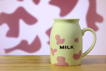 Pink and white pattern milk cup on table