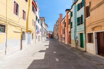 Street feature with multicolored houses in Chioggia, the little