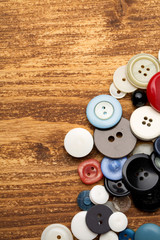Set of vintage buttons on old wooden table