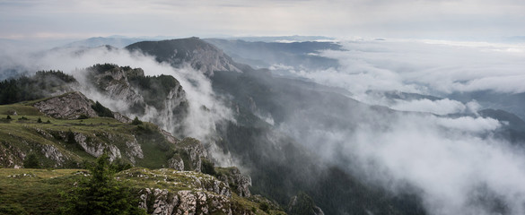 Foggy Landscape in mountains. A view from mountains to the valley covered with foggy landscape.