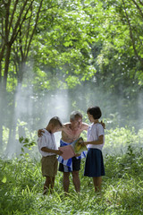 Fototapeta premium Happy children is reading book in rubber plantation