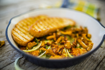 Chantarelle mushrooms on a frying pan
