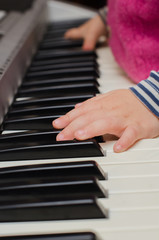 Fototapeta na wymiar child plays the piano