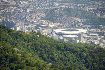 Rio de Janeiro, Brazil city skyline view from above featuring misty crowded cityscape beyond jungle greenery