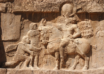 Ancient relief of the necropolis Naqsh-e Rustam that shows the triumph of Shapur I over the Roman Emperor Valerian and Philip the Arab, near ruins of Persepolis