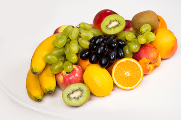 Fototapeta na wymiar A plate of fresh fruit closeup. Healthy eating, diet and vitamins
