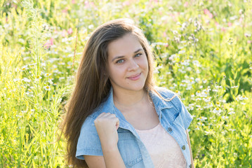 Beautiful teen girl in meadow in summer