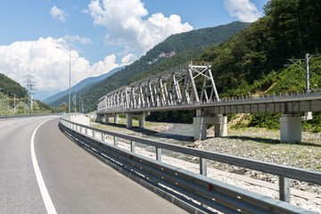 Fototapeta na wymiar highway and railway bridge over Mzymta River in the mountains