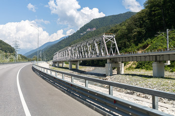 highway and railway bridge over Mzymta River in the mountains