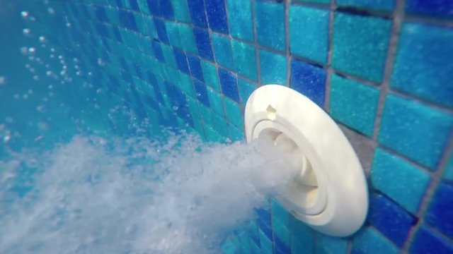 pool water jet filling hose, underwater view of thermal spa 