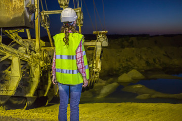 female worker lookis at sandpit on backgroud of career stacker