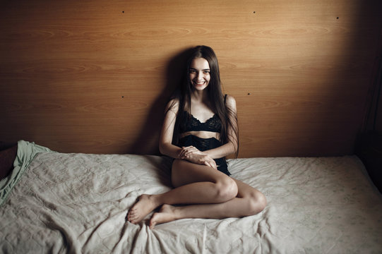 Woman sitting on bed