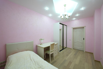 Simple interior room with pink walls for girl with a bed, a table and sliding door wardrobe