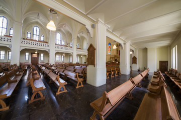 pews, altar and stained glass windowson the mraornom floor of Cathedral of St. Peter and Paul