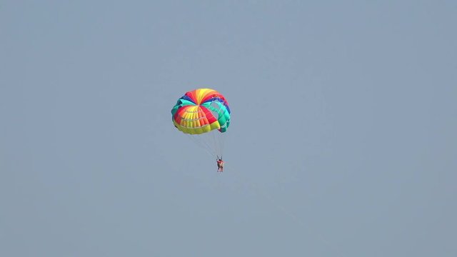  Man sportsman windsurfer flying on parachute. Double tandem flight