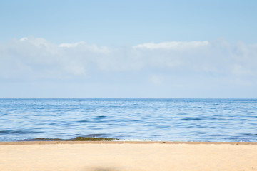 Fototapeta na wymiar Sunny morning on empty sandy beach in summer