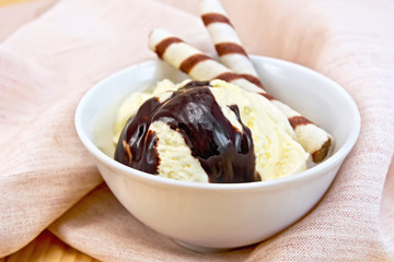 Ice cream vanilla with wafer rolls on napkin