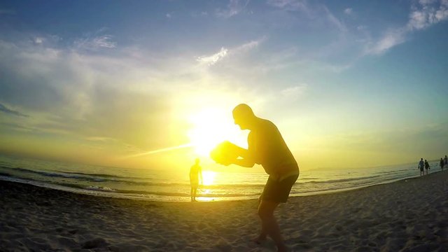 silhouette Playing Frisbee on sunset, slow motion 120fps