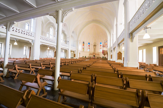 pews, altar and stained glass windows under the vault of Cathedral of St. Peter and Paul