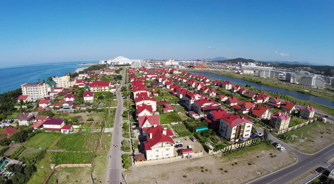 Street in town-hotel Barhatnye Sezony near pond and Fisht Olympic Stadium. Aerial view. Photo with noise from action camera.