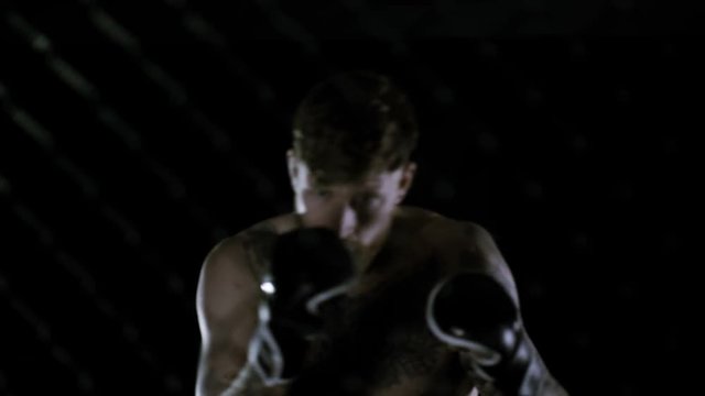  Muscular MMA fighter training alone in dark environment