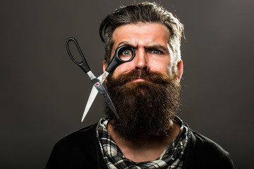 bearded man with hairdresser scissors