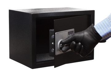 Naklejka premium Man's hand in a striped shirt and black gloves breaking a safe, isolated on white. Small home or hotel safe