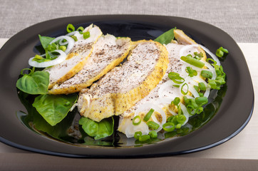 Closeup view of the sliced grilled chicken decorated with basil