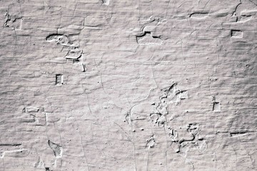 Vintage white cracked wall background.